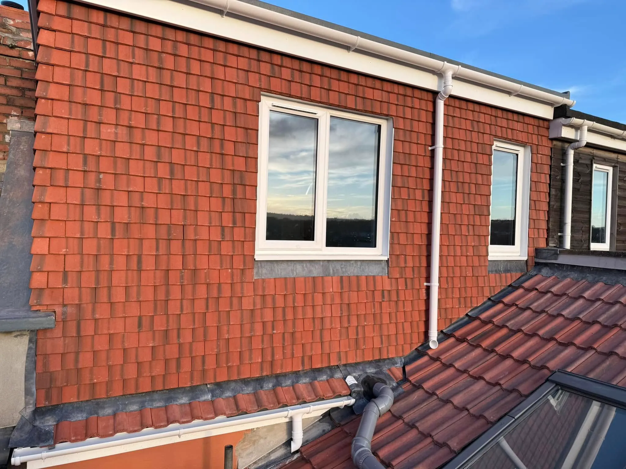A red brick building with a skylight on top of it.
