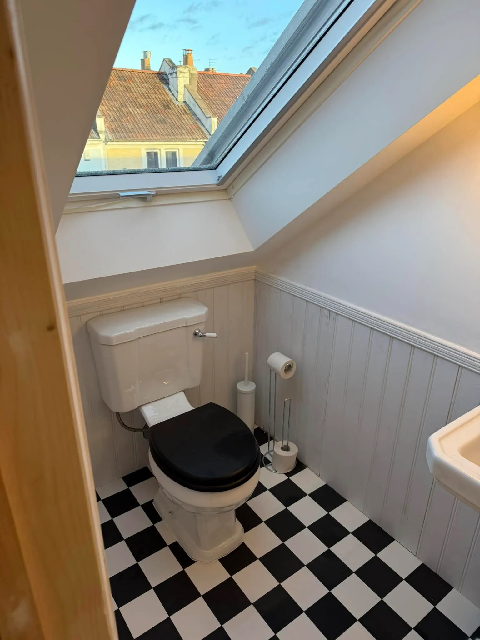 A bathroom with a black and white checkered floor.