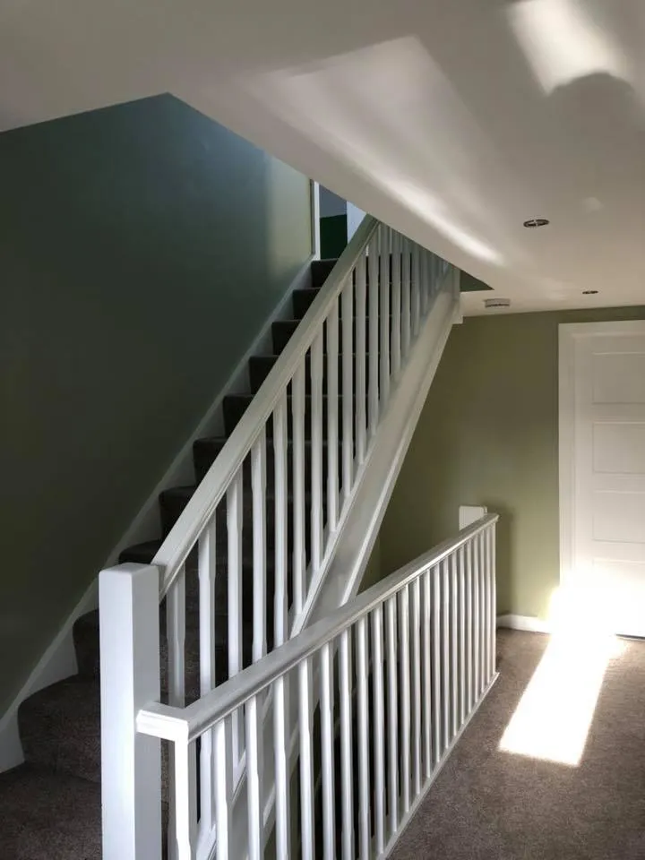 an empty room with a staircase and a door