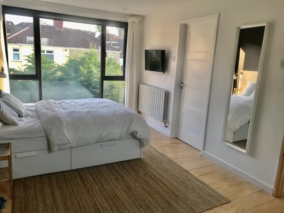 a bedroom with a large bed and a large window
