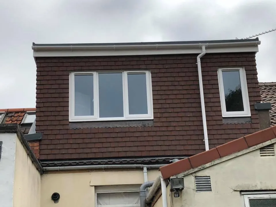 a couple of windows on the side of a building