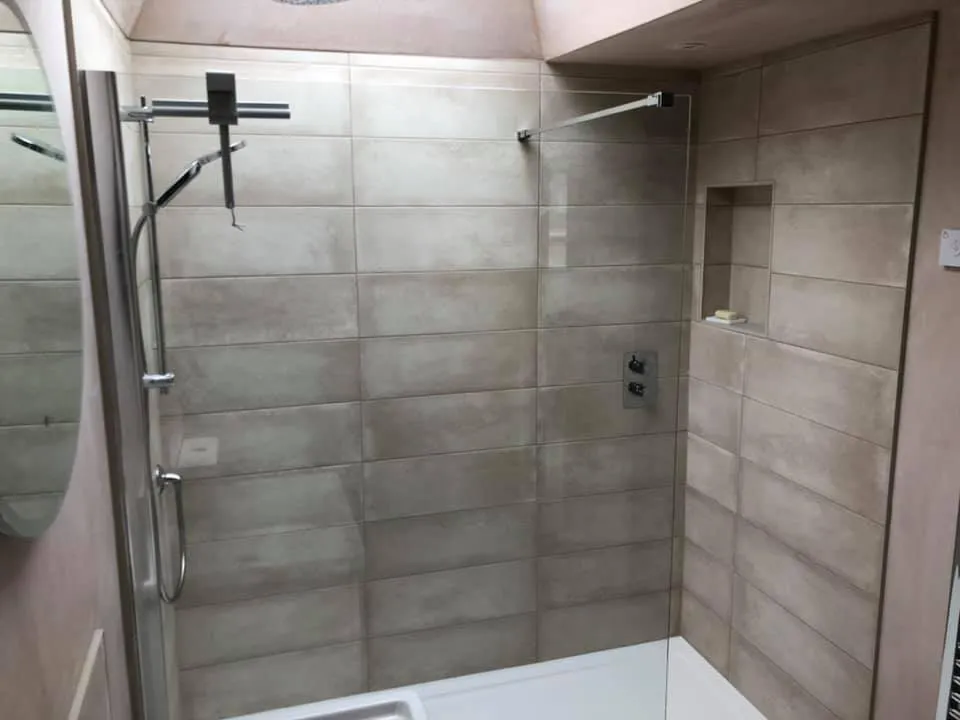 a walk in shower sitting next to a sink
