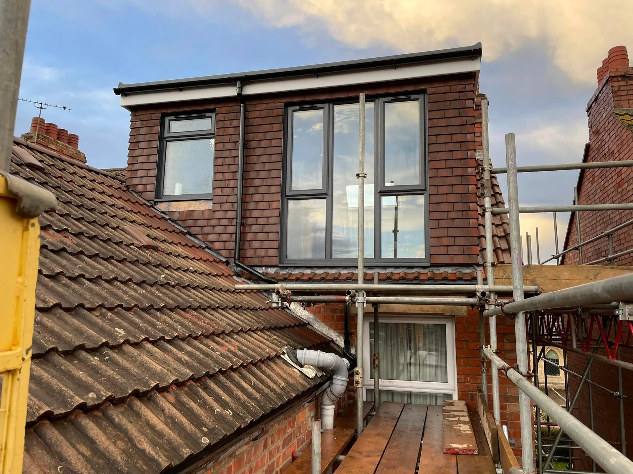 a house with a ladder up to it's roof