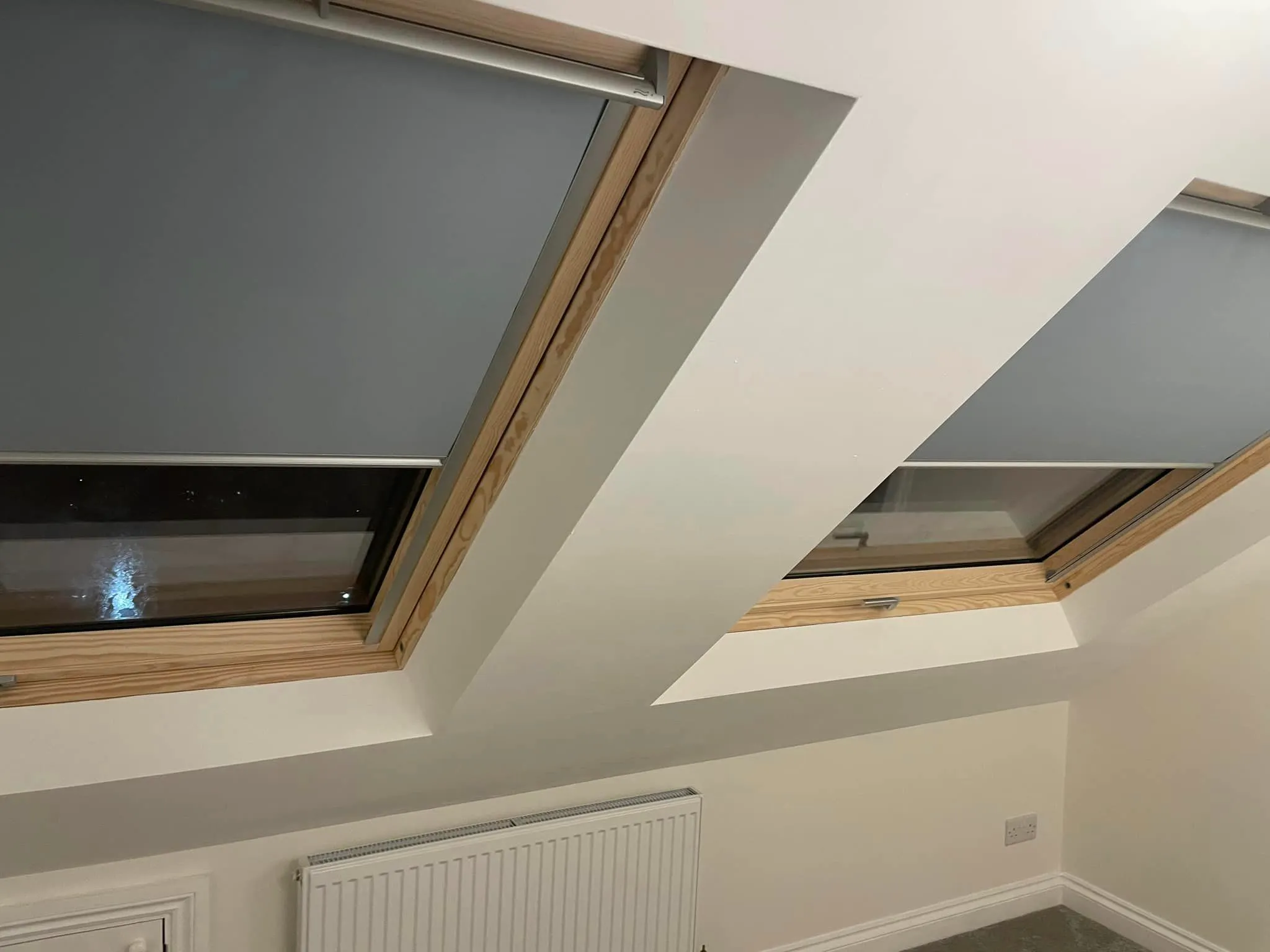 a room with two skylights and a radiator